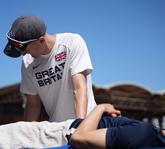 A Solution Clinic therapist treating an athlete at a competition